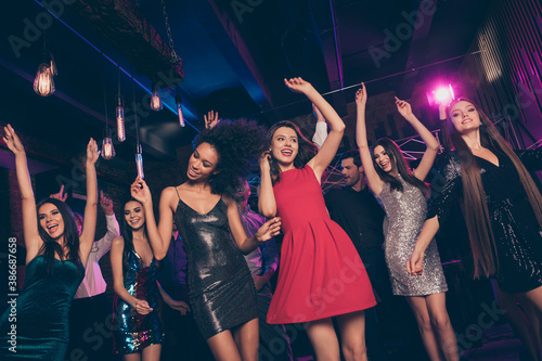 Nice-looking attractive elegant trendy cheerful crowd dancing enjoying corporate event social life in dark night club indoors