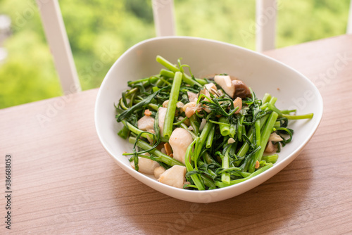 stir fried green morning glory with garlic and mushroom photo