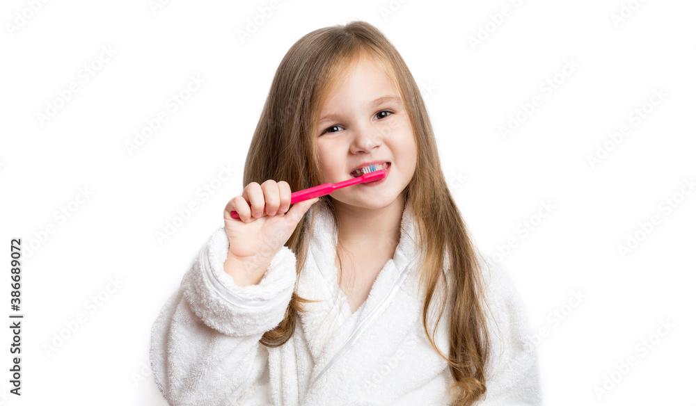 little girl brushes her teeth smiling on a white background. dental care. prevention of caries. little girl brushes her teeth smiling on a white background. dental care. prevention of caries.