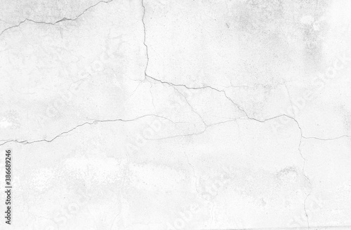 The black and white concept of a plain white plastered brick wall with cracks for backgrounds, patterns and textures for backgrounds. Concrete surfaces are slightly rough. Random seamless wall pattern