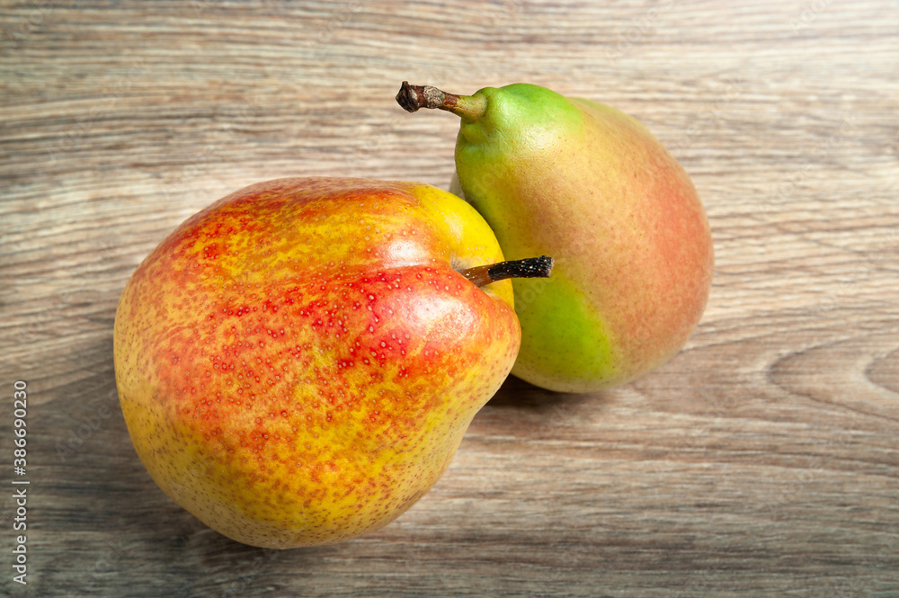 Juicy pears. Two fresh ripe organic pears on a wooden background. Vegetarian, vegan healthy food. Diet organic product. Selective soft focus. Juicy pears. Two fresh ripe organic pears on a wooden background. Vegetarian, vegan healthy food. Diet organic product. Selective soft focus.