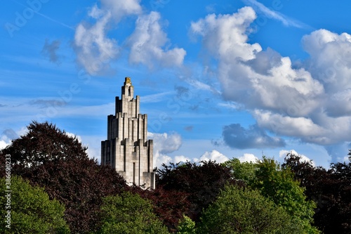 Landscape with War Memorial among trees against blue sky with picturesque clouds, Coventry, England, UK photo