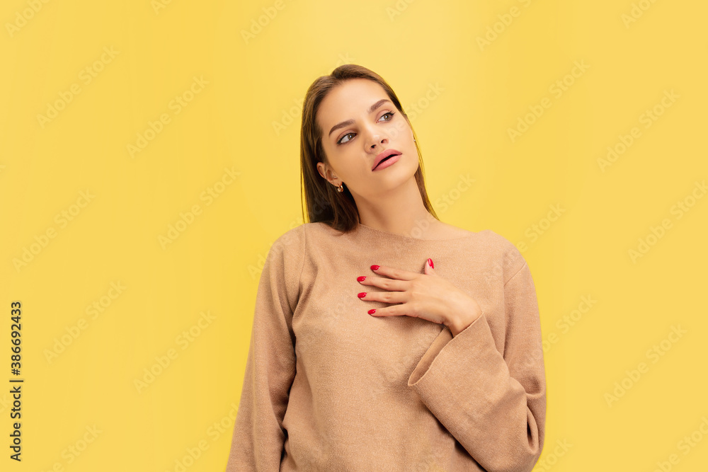 Tired. Portrait of young caucasian woman isolated on yellow studio background with copyspace. Beautiful female model. Concept of human emotions, facial expression, sales, advertising, youth. Tired. Portrait of young caucasian woman isolated on yellow studio background with copyspace. Beautiful female model. Concept of human emotions, facial expression, sales, advertising, youth.