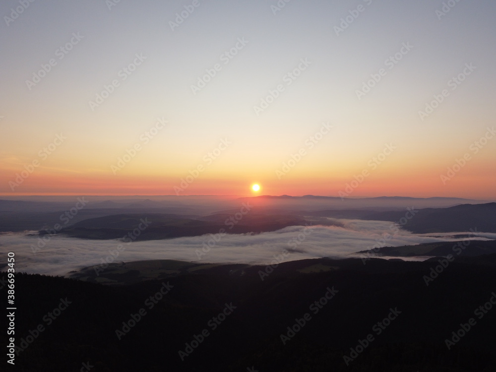 Sunrise with fog in mountains