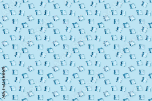 Seamless pattern of scattered ice cubes on blue background  top view.