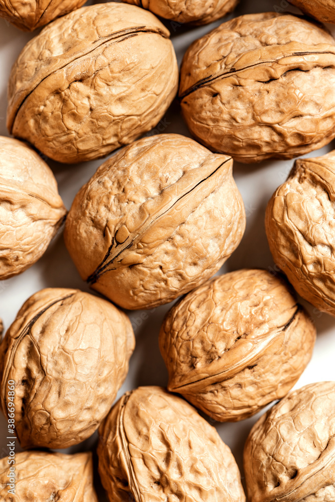 Walnuts on a white background top view. Soft focus. Stylish food background with nuts. Walnuts on a white background top view. Soft focus. Stylish food background with nuts.