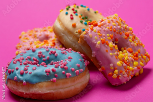 Colored donuts, on a pink background.