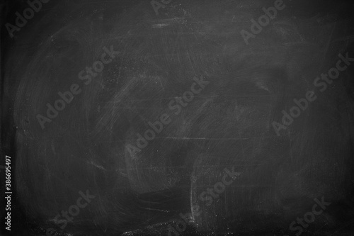Abstract texture of chalk rubbed out on blackboard or chalkboard background. School education, dark wall backdrop or learning concept.