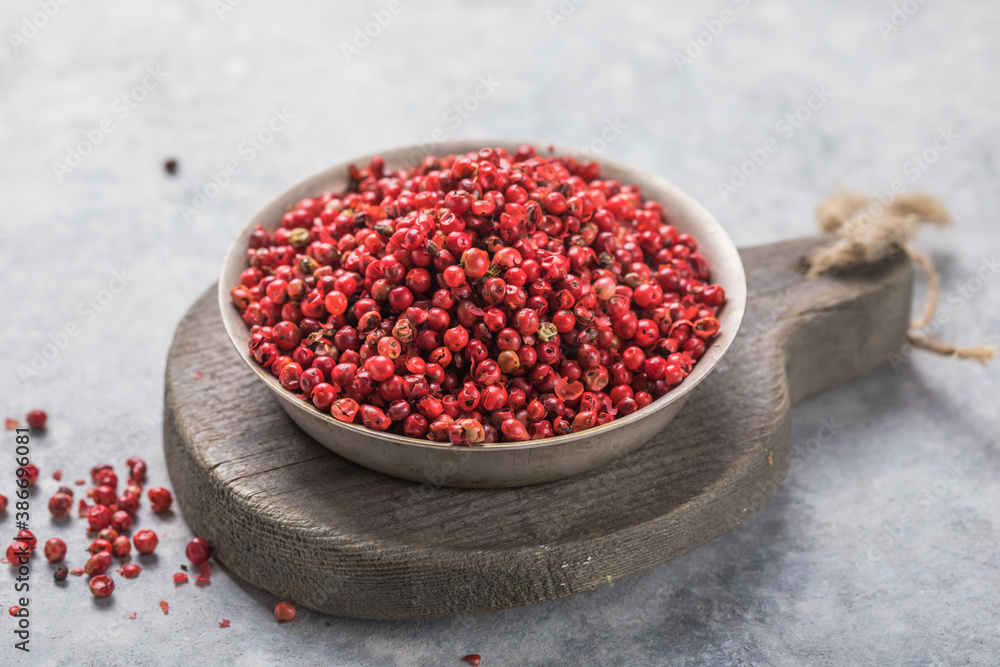 Spoon of red peppercorn on concrete background Spoon of red peppercorn on concrete background