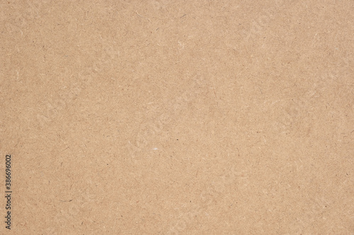 Texture of brown craft or kraft paper background, cardboard sheet, recycle paper, copy space for text.