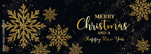 card or banner on "merry christmas and happy new year" in gold with gold colored snowflakes and glitter on a black background