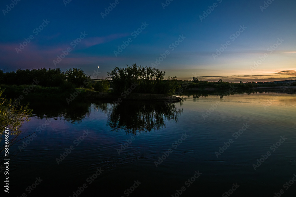 the still surface of the lake reflects a beautiful evening with the glow of sunset the still surface of the lake reflects a beautiful evening with the glow of sunset