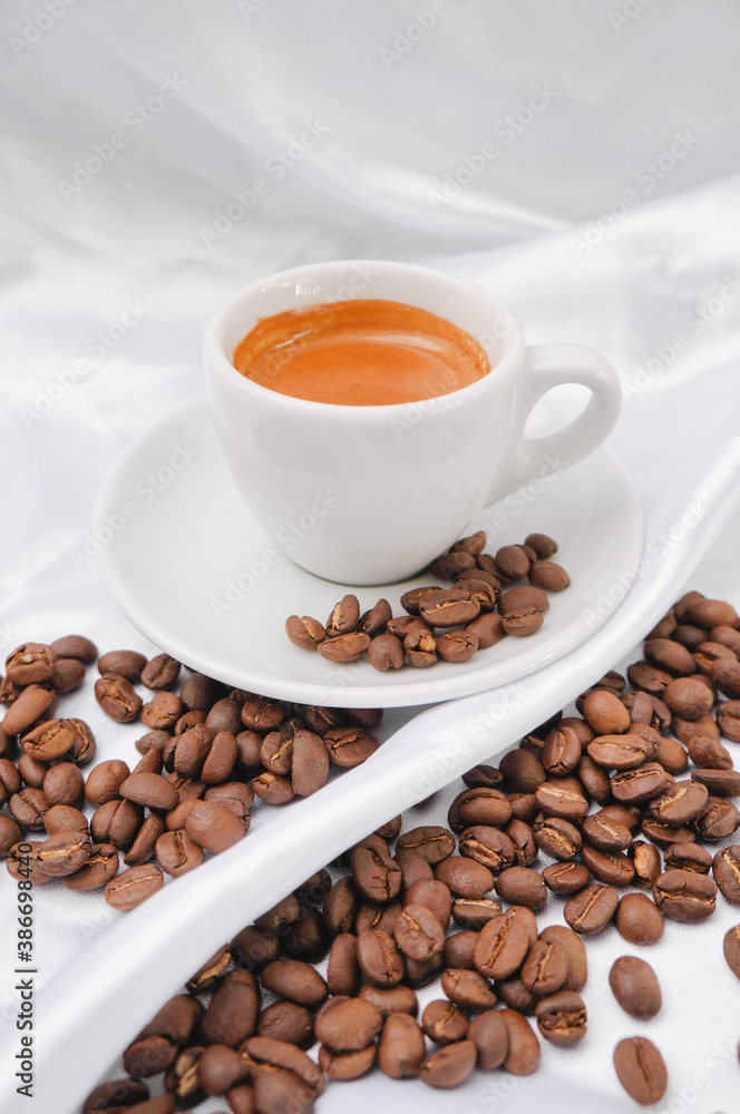 Fototapeta premium Espresso coffee and coffee beans on a white background