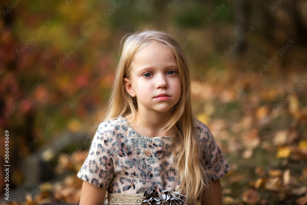 Close-up portrait of pretty little girl resting in autumnal park Close-up portrait of pretty little girl resting in autumnal park
