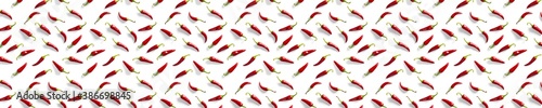Creative background made of red chili or chilli on white backdrop. Minimal food backgroud. Red hot chilli peppers background.