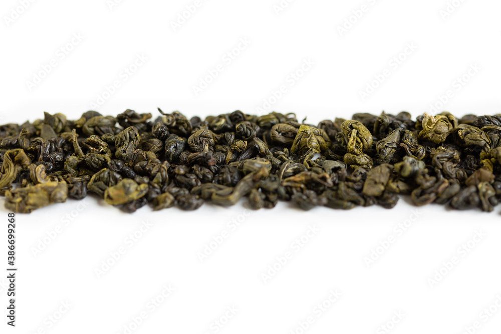 Green tea, on a white background, tea scattered on a white background. Green tea, on a white background, tea scattered on a white background.