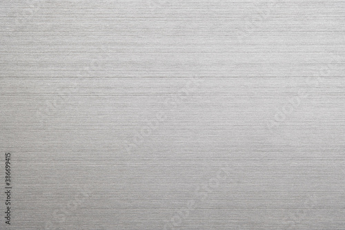 Silver metal texture of brushed stainless steel plate with the reflection of light. © tonstock