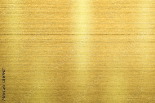 Gold metal texture of brushed stainless steel plate with the reflection of light.