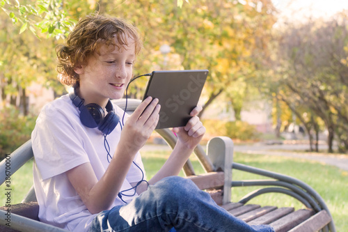 teenager 11 years old with a tablet outdoors