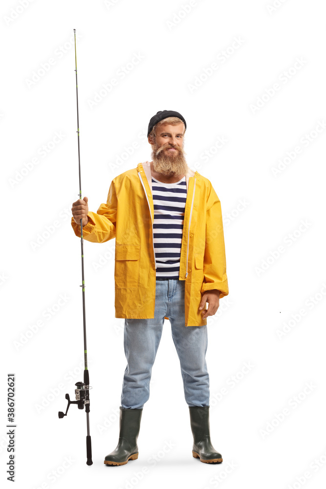 Full length portrait of a bearded young fisherman holding a fishing rod and smiling - obrazy, fototapety, plakaty 