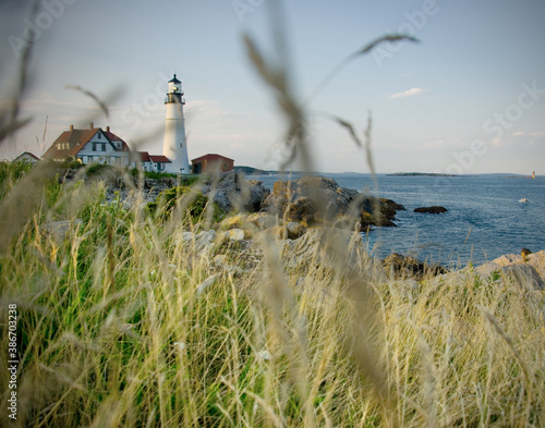 Lighthouse on the coast of Maine at sunset during summer