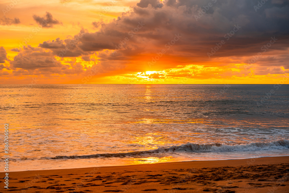 View of Beautiful glorious golden sunset and golden hour above the sea in evening