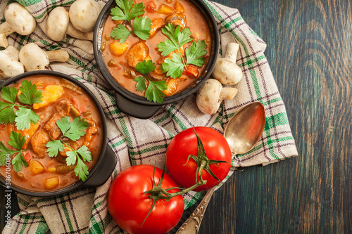 Stew soup with meat, potatoes, mushrooms and red pepper