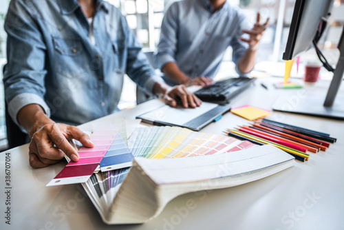 Young colleagues designers working together on a creative project and color samples for selection, Color swatch samples, Brainstorming Planning Partnership, creative graphic design working desktop