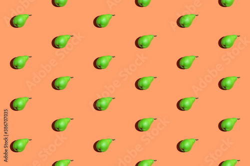 Green pears pattern. Colorful seamless pattern of fresh pears on an orange background. Fresh ripe organic pears isolated on orange surface. Vegan, vegetarian healthy food.