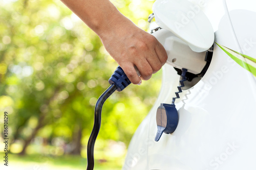 Electric car battery charging at charge station in the nature photo