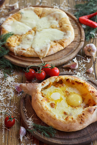Georgian cuisine. Food photo. Khachapuri on wooden boards. Appetizing bright photo.