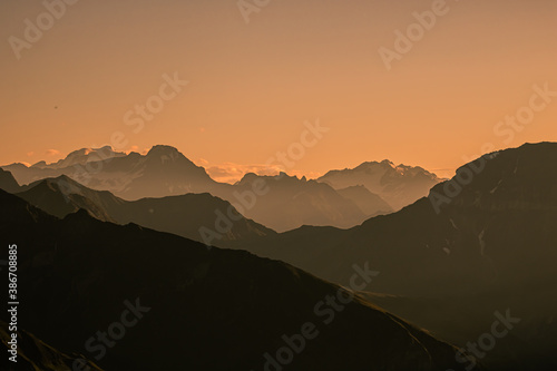 sunrise over the swiss Alps, Switzerland. sillhouettes of mountains