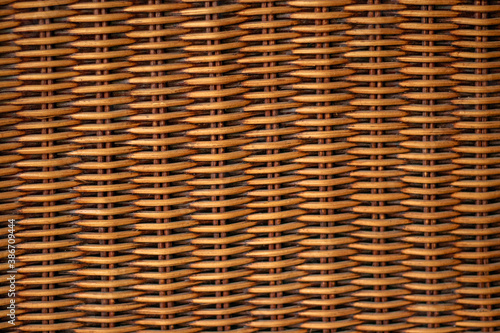 Texture weaving patterns vine on a black background. Wicker Straw Basket