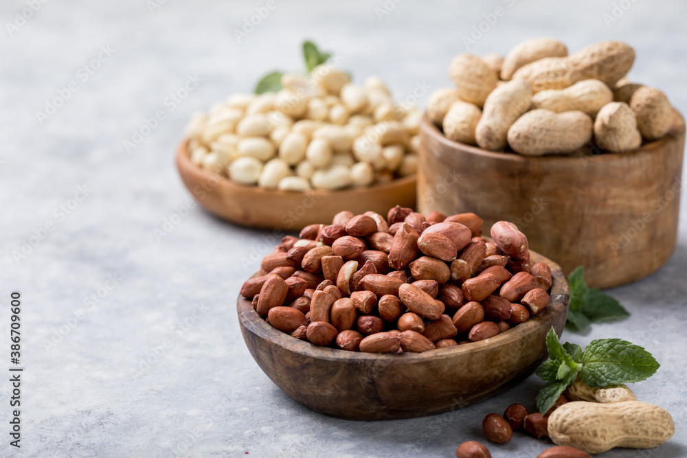 Raw dried fresh peanut nuts on a stone background Raw dried fresh peanut nuts on a stone background