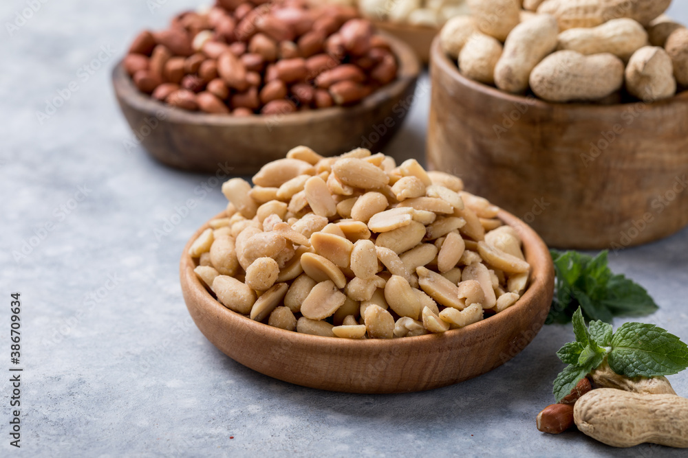 Roasted salted peanuts. Crispy nuts in bowl on stone table. Roasted salted peanuts. Crispy nuts in bowl on stone table.
