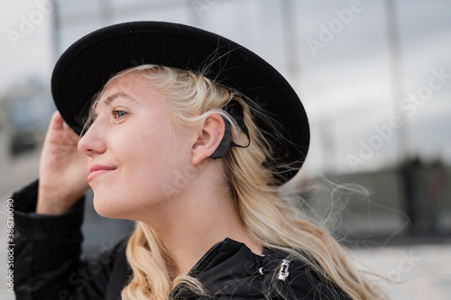 Portrait of a blonde woman wearing a Hearing Aid