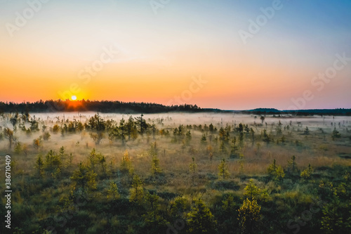 Aerial view of sunrise over marshland in autumn coloured national park in Finland