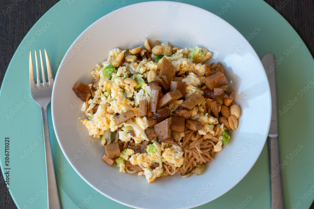 Asian noddles with omelette, peanuts, spicy red pepper and ketyap and vegetarian meat called seitan Asian noddles with omelette, peanuts, spicy red pepper and ketyap and vegetarian meat called seitan