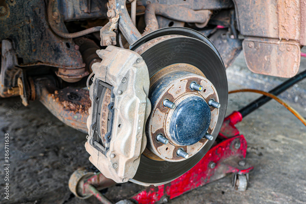 Closeup of car disc brake at Garage. Closeup of car disc brake at Garage.