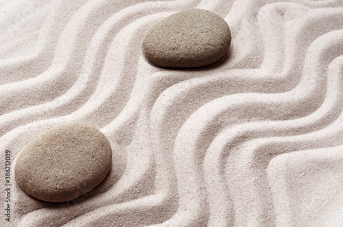 zen meditation stone background with stones and lines in sand for relaxation balance and harmony spirituality or spa wellness