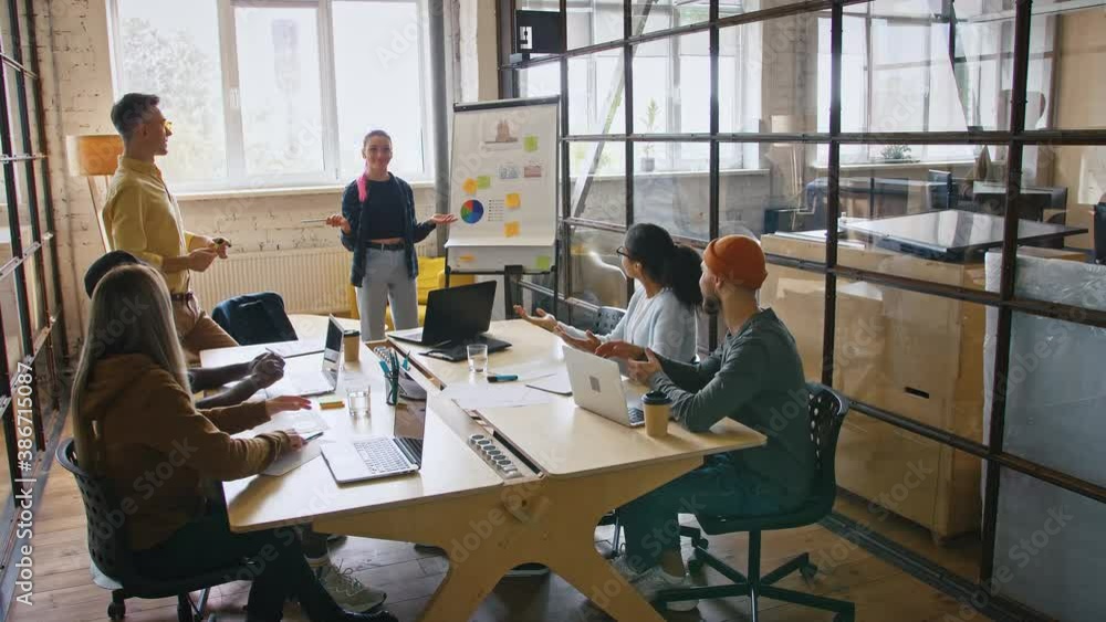 New business achievement. Team leader making presentation for colleagues, coworkers enjoying success and clapping hands New business achievement. Team leader making presentation for colleagues, coworkers enjoying success and clapping hands