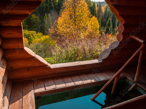 Holy spring and wooden house with plunge font pool for ablutions, relaxing in a natural park. photo
