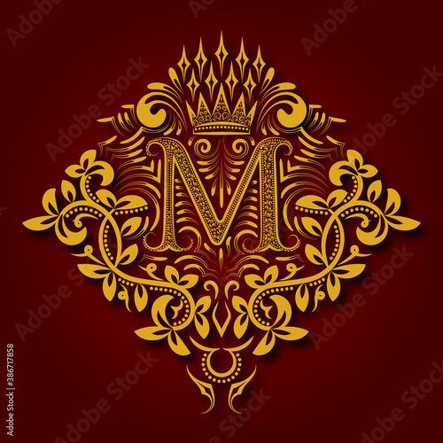 Letter M heraldic monogram in coats of arms form. Vintage golden logo with shadow on maroon background. Letter M is surrounded by floral elements of design.