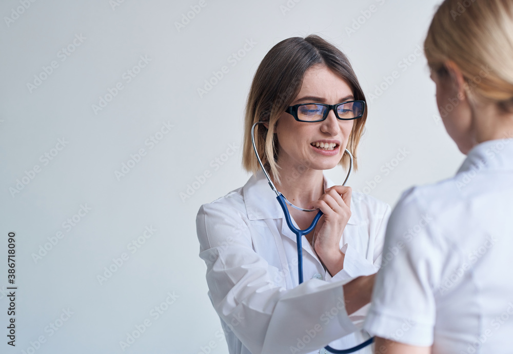 professional woman doctor in medical gown and glasses blue stethoscope patient professional woman doctor in medical gown and glasses blue stethoscope patient