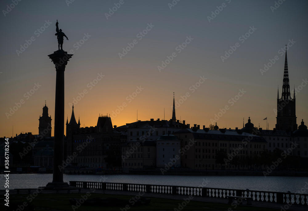 Orange silhouette skyline over the old town Gamla Stan in Stockholm at sunrise