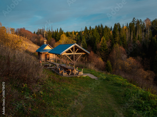 Holy spring and wooden house with plunge font pool for ablutions, gazebo for relaxing in a natural park. photo