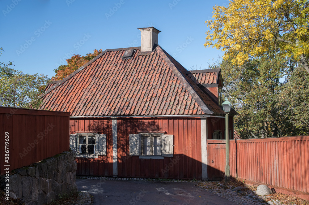 Autumn view of old wood house in a park in Stockholm. Autumn view of old wood house in a park in Stockholm.