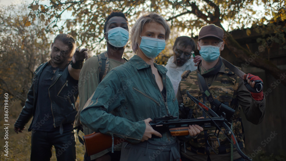Zombie hunter team in safety mask with weapon and two monsters on background Zombie hunter team in safety mask with weapon and two monsters on background