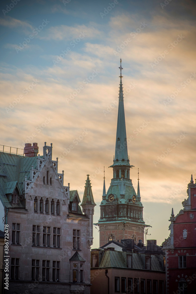 Backlight profiles of buildings and church in the old town Gamla Stan in Stockholm at sunrise