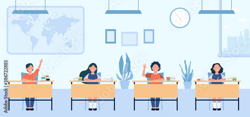 Happy pupils studying in classroom isolated flat vector illustration. Cartoon children characters sitting at tables in school lesson. Study, exam and interior clipart concept